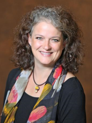 a profile picture of Julie Greenberg, a speaker at the conference.