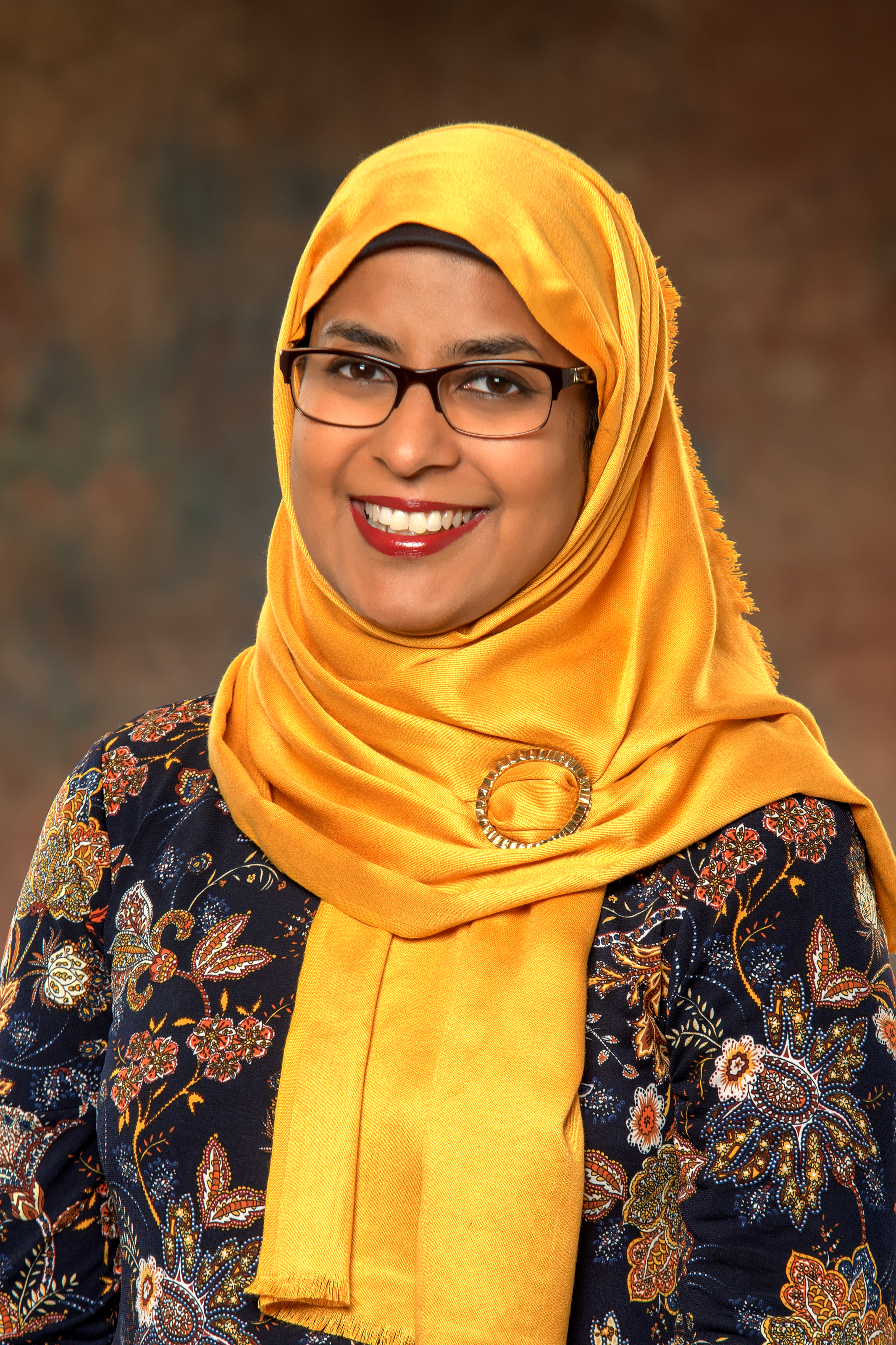 a profile picture of Sabina Mohyuddin, a speaker at the conference.